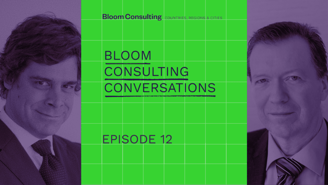 Promotional graphic for "Bloom Consulting Conversations" podcast featuring portraits of Jose Filipe Torres and Dr. Keith Dinnie from Bloom Consulting, with a green grid background and bold text highlighting the podcast title.